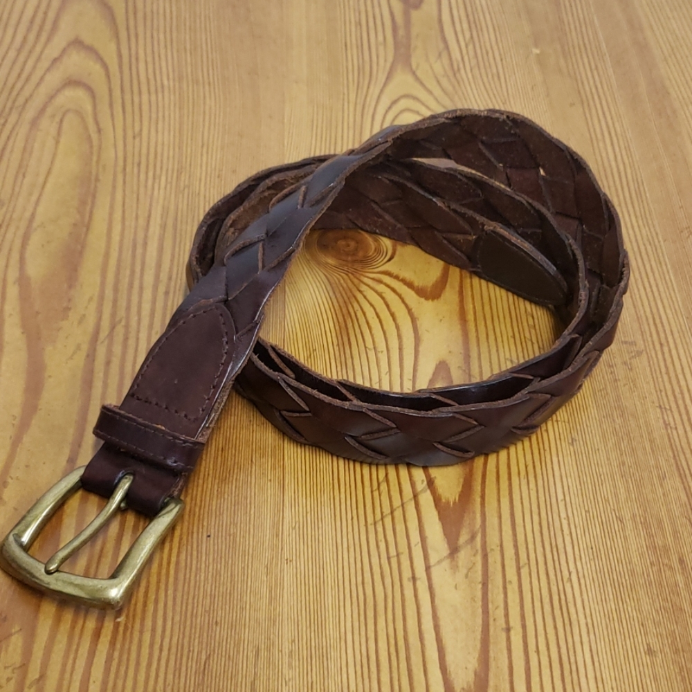 Brown leather braided belt with brass buckle.